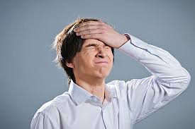 man is upset with hands on face